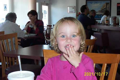 Tired from smiling, Ella forces her mouth into postion with her fingers